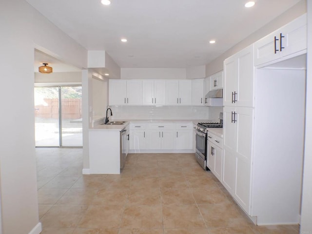 kitchen with sink, stainless steel appliances, white cabinetry, and light tile patterned flooring