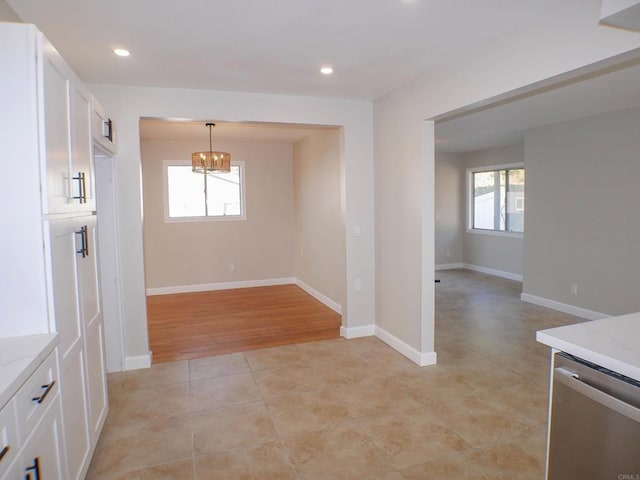 unfurnished dining area featuring light wood-type flooring and plenty of natural light