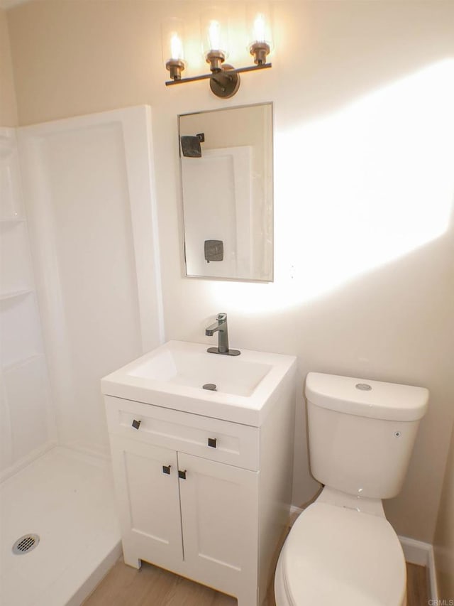 bathroom featuring hardwood / wood-style flooring, vanity, and toilet