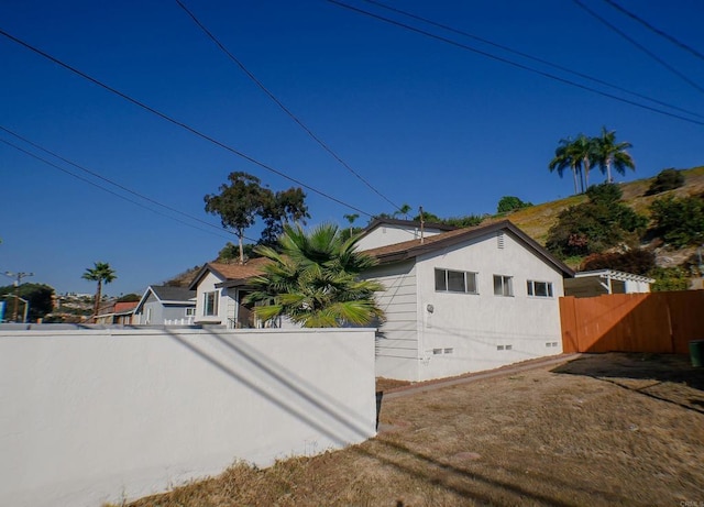 view of property exterior with a lawn