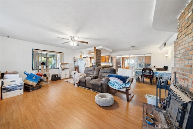 living room with ceiling fan and light hardwood / wood-style flooring