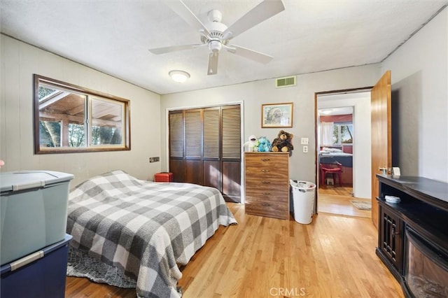 bedroom featuring a closet, ceiling fan, and light hardwood / wood-style floors