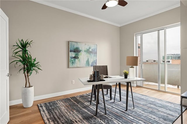 office space featuring crown molding, wood finished floors, baseboards, and ceiling fan