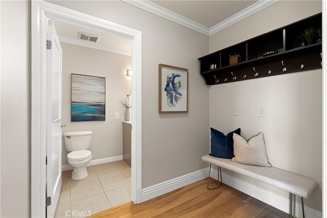 mudroom featuring visible vents, baseboards, light tile patterned flooring, and crown molding