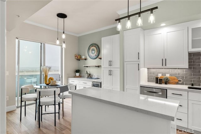 kitchen with light wood finished floors, backsplash, open shelves, ornamental molding, and stainless steel dishwasher