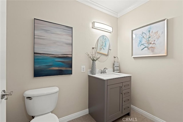 half bathroom with vanity, toilet, baseboards, and ornamental molding