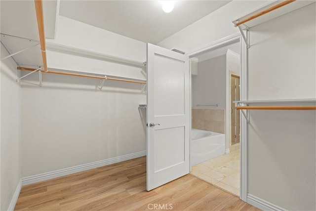 spacious closet featuring visible vents and light wood-type flooring