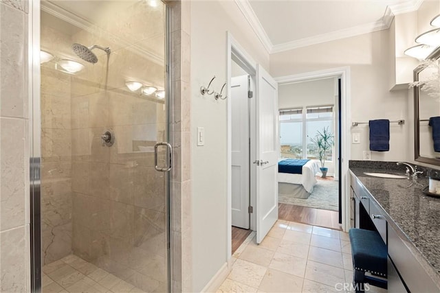 bathroom with a shower stall, connected bathroom, baseboards, ornamental molding, and vanity