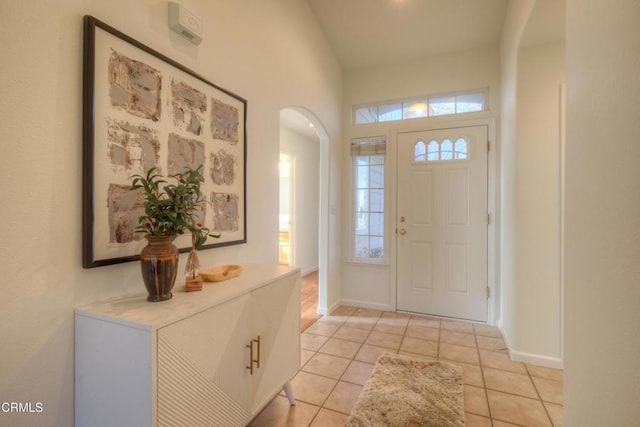 foyer entrance featuring light tile patterned flooring and plenty of natural light