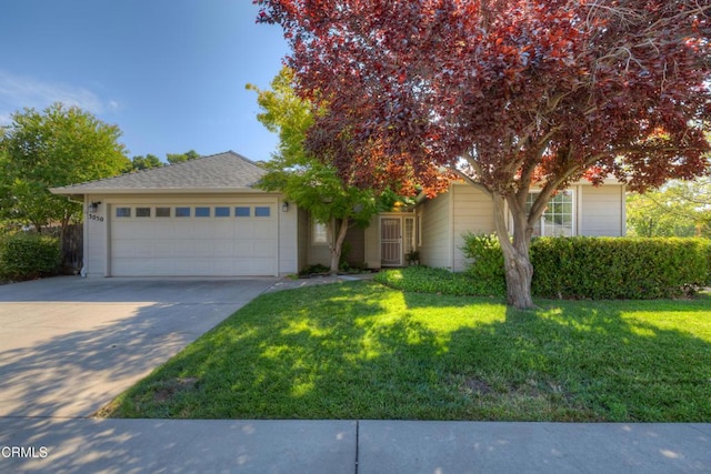 obstructed view of property featuring a front lawn and a garage