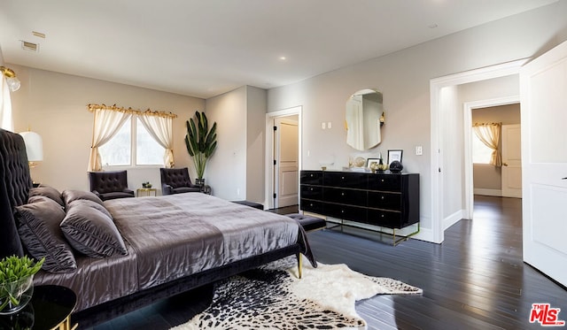 bedroom featuring dark hardwood / wood-style flooring