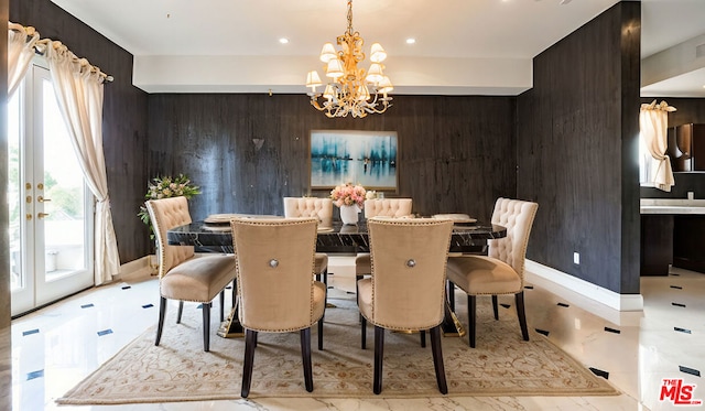 dining area featuring an inviting chandelier, a wealth of natural light, and wood walls