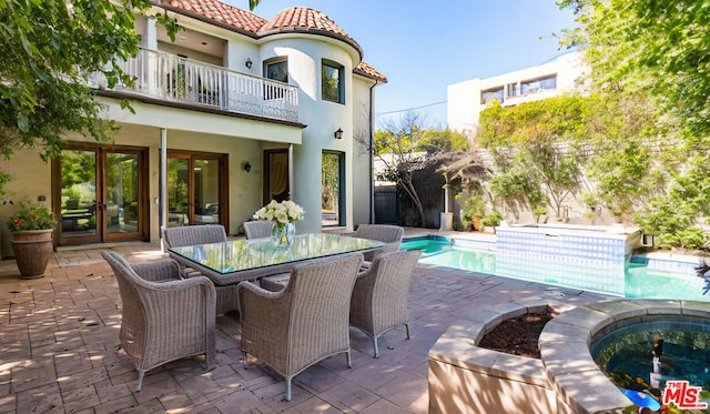 view of patio / terrace with french doors and a balcony