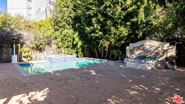 view of pool featuring an in ground hot tub and a patio area