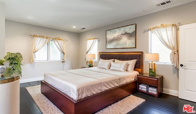 bedroom with dark hardwood / wood-style flooring