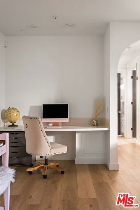 office featuring built in desk and light hardwood / wood-style flooring