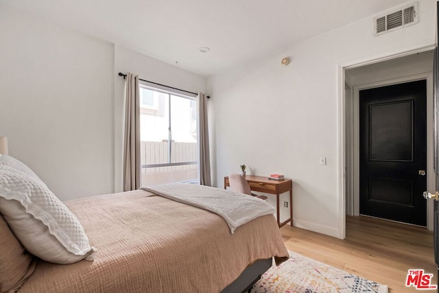 bedroom with light hardwood / wood-style floors