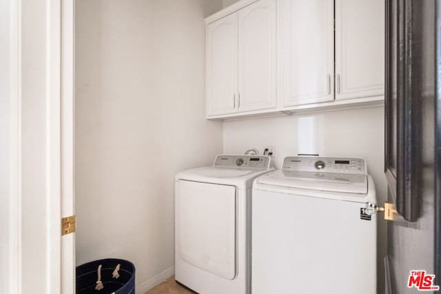 laundry area with cabinets and separate washer and dryer