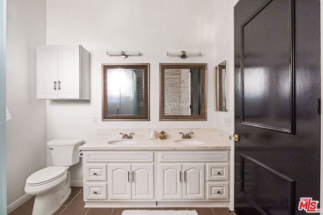 bathroom featuring tile patterned flooring, vanity, and toilet