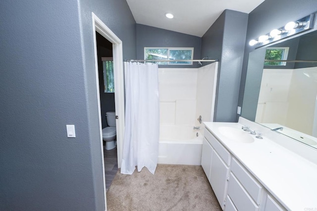 full bathroom featuring lofted ceiling, toilet, a wealth of natural light, and shower / bath combo with shower curtain