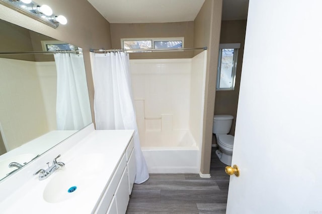 full bathroom featuring shower / tub combo, hardwood / wood-style floors, vanity, and toilet