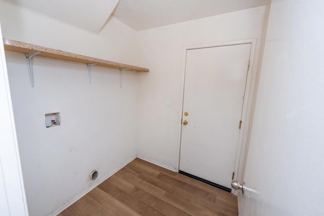 clothes washing area with light hardwood / wood-style floors and hookup for a washing machine