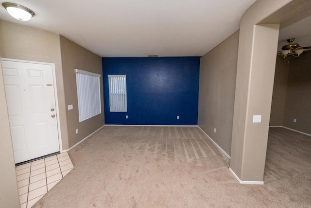 carpeted foyer entrance with ceiling fan