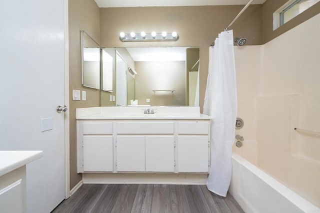 bathroom with shower / bathtub combination with curtain, wood-type flooring, and vanity