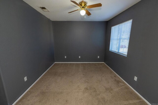 carpeted empty room with ceiling fan