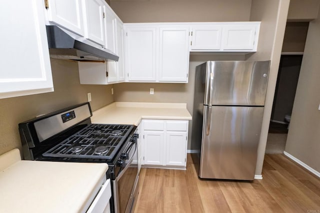 kitchen with stainless steel appliances, white cabinetry, and light wood-type flooring