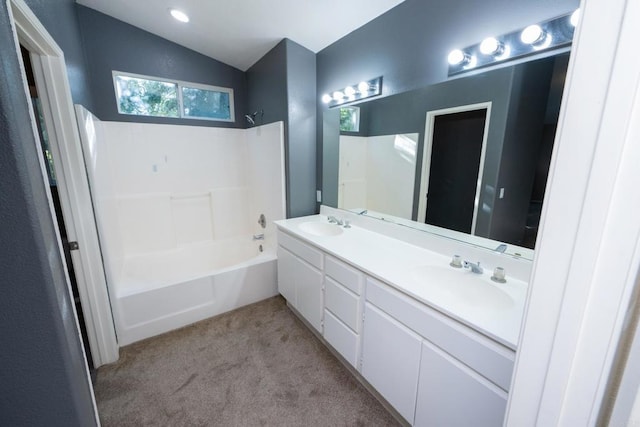 bathroom with shower / bathtub combination, lofted ceiling, and vanity