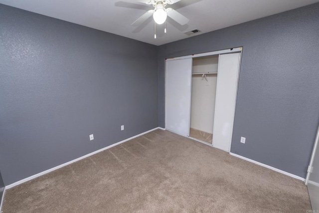 unfurnished bedroom with a closet, ceiling fan, and carpet