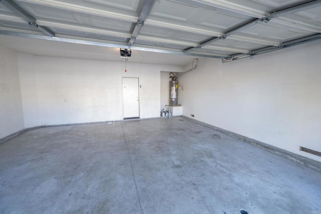 garage featuring water heater and a garage door opener