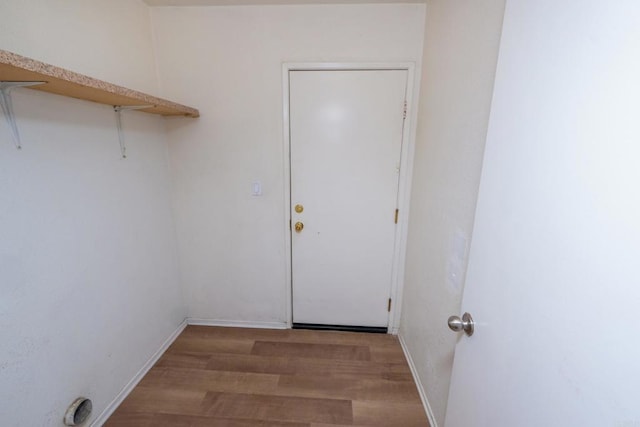 laundry room with hardwood / wood-style flooring