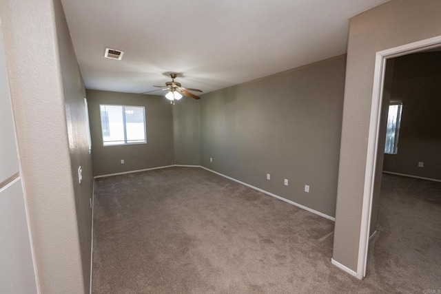 carpeted empty room with ceiling fan