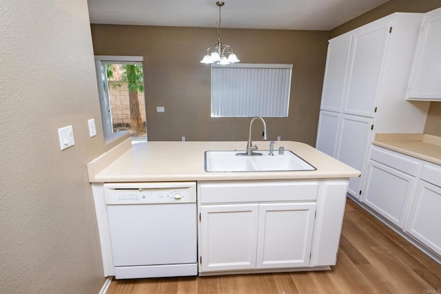 kitchen with sink, white cabinetry, dishwasher, hanging light fixtures, and a chandelier