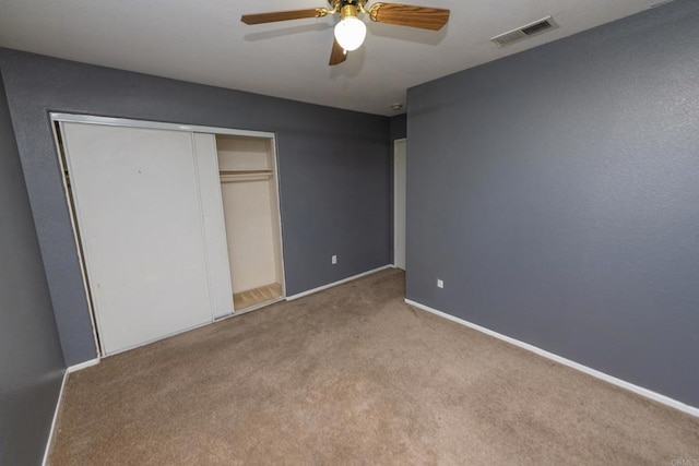 unfurnished bedroom with a closet, ceiling fan, and light colored carpet