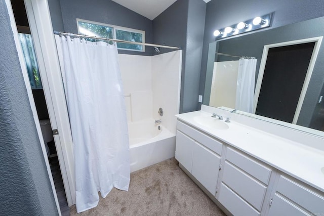 bathroom with vaulted ceiling, shower / tub combo with curtain, and vanity