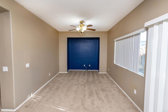 unfurnished room featuring ceiling fan and light colored carpet