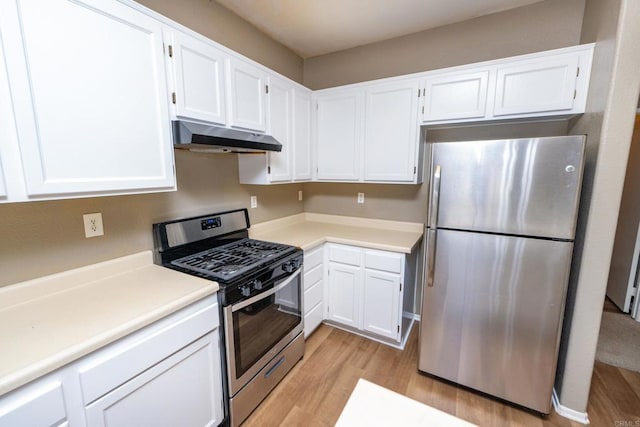 kitchen featuring appliances with stainless steel finishes, light hardwood / wood-style flooring, and white cabinetry