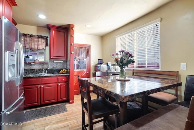 kitchen featuring sink, stainless steel fridge with ice dispenser, and tasteful backsplash