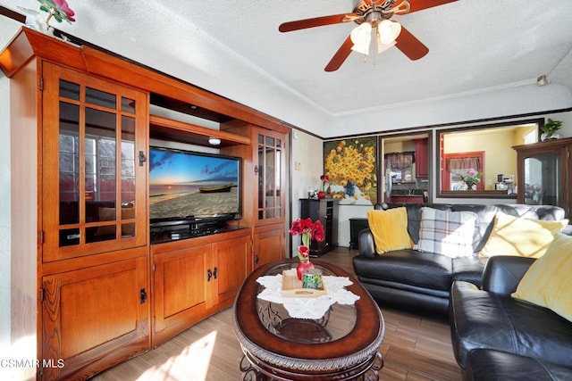 living room featuring a textured ceiling, ceiling fan, and light hardwood / wood-style flooring