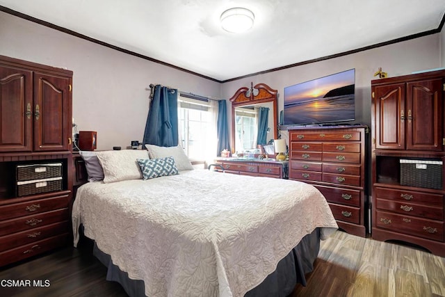 bedroom with ornamental molding and dark hardwood / wood-style floors