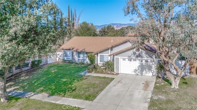 ranch-style house featuring a garage, a front lawn, and a mountain view