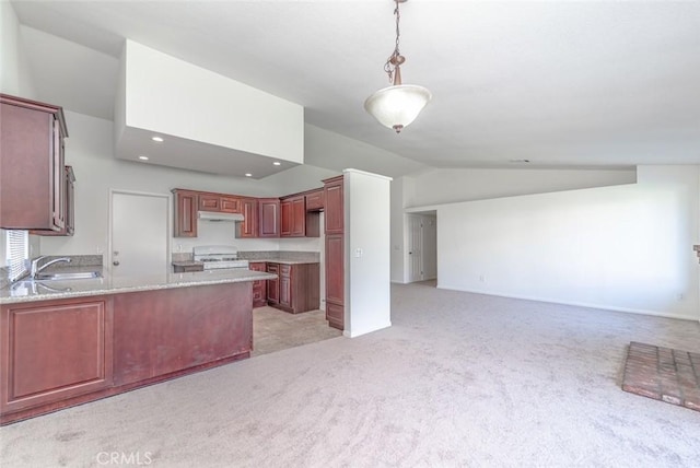 kitchen featuring kitchen peninsula, white gas range, decorative light fixtures, lofted ceiling, and sink