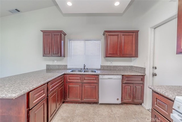 kitchen with sink, dishwasher, light tile patterned flooring, kitchen peninsula, and range