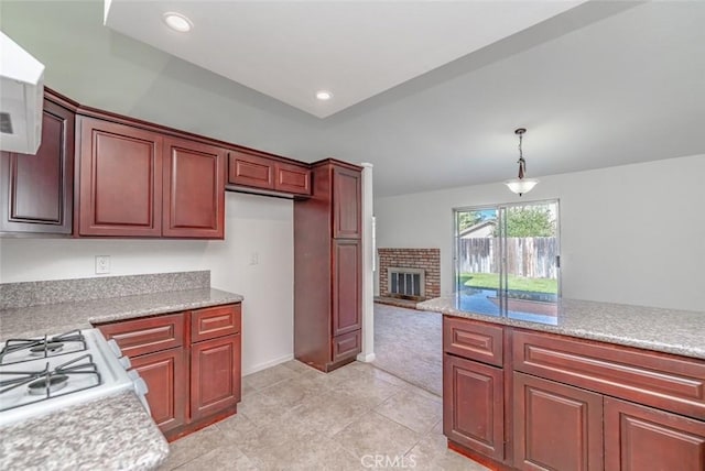 kitchen with light tile patterned floors, a fireplace, pendant lighting, and white range oven