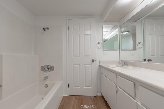 bathroom with tub / shower combination, vanity, and wood-type flooring