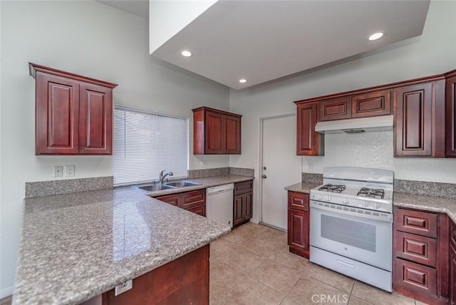 kitchen with white appliances, light tile patterned floors, and sink