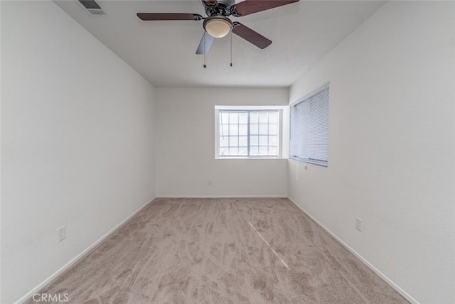 spare room featuring ceiling fan and light carpet